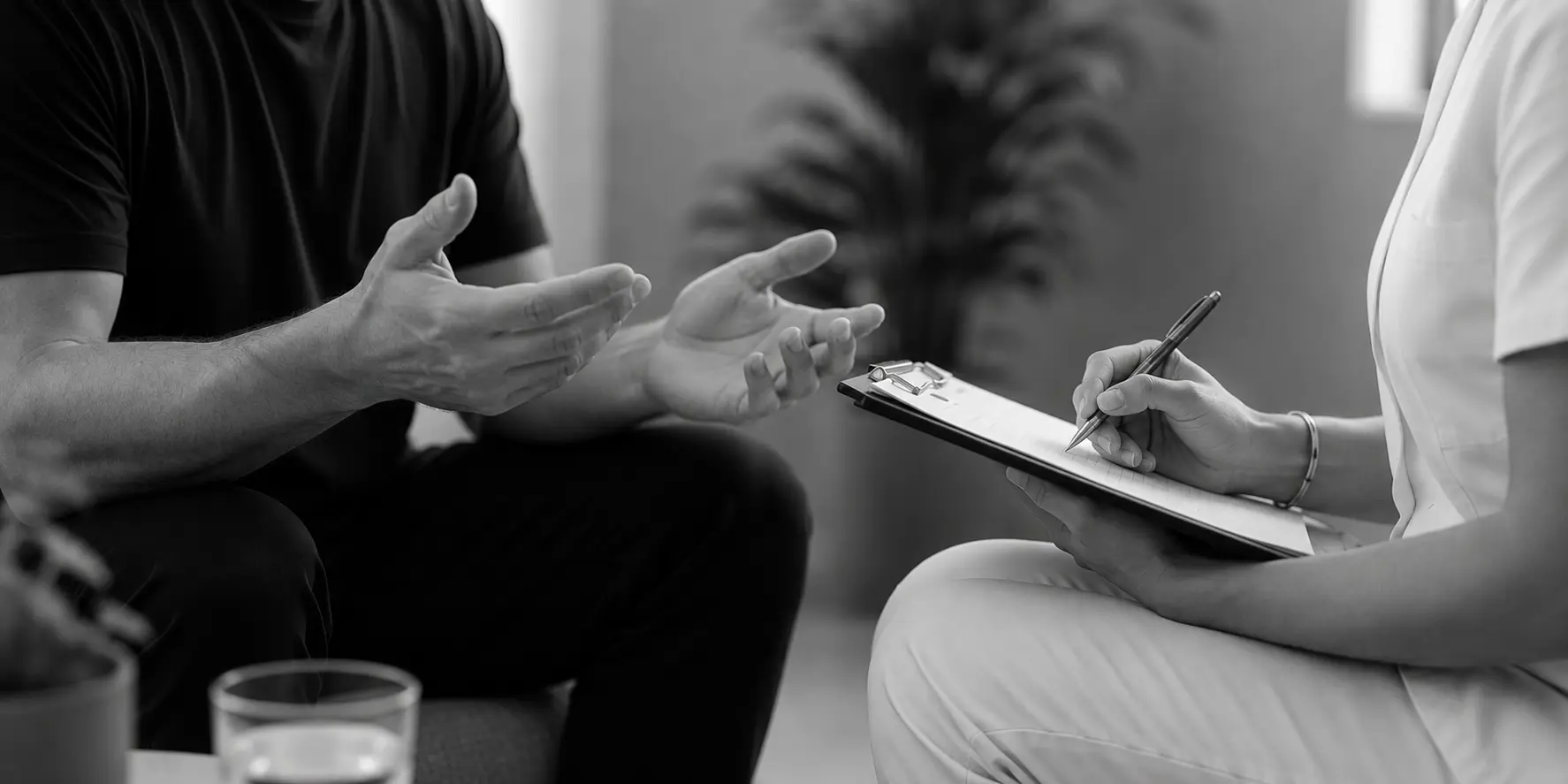 Clinician taking notes during a wellness consultation